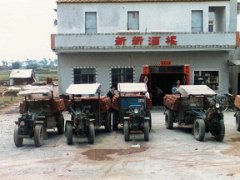1987-04 China (15) 1987 - China Farm tractors carrying bricks outside a restaurant on the Schenzhen to Dongguan road. These kind of tractor/trailers were (are) very common in...